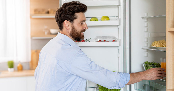 Man grabbing food from fridge.